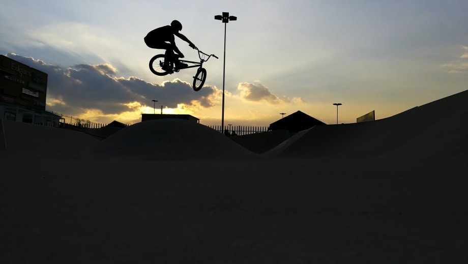 a bmx rider casts a silhouette over a skatepark in edenvale gauteng.