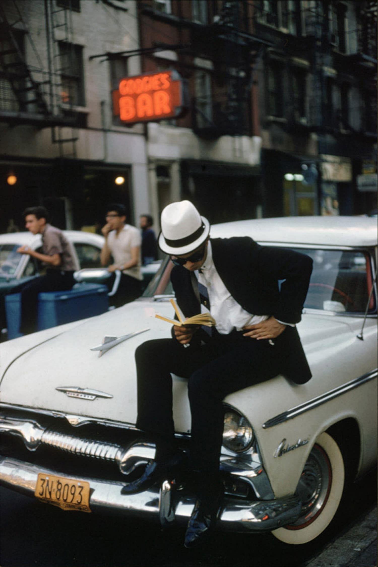 ernst haas man reading on a plymouth new york 1964