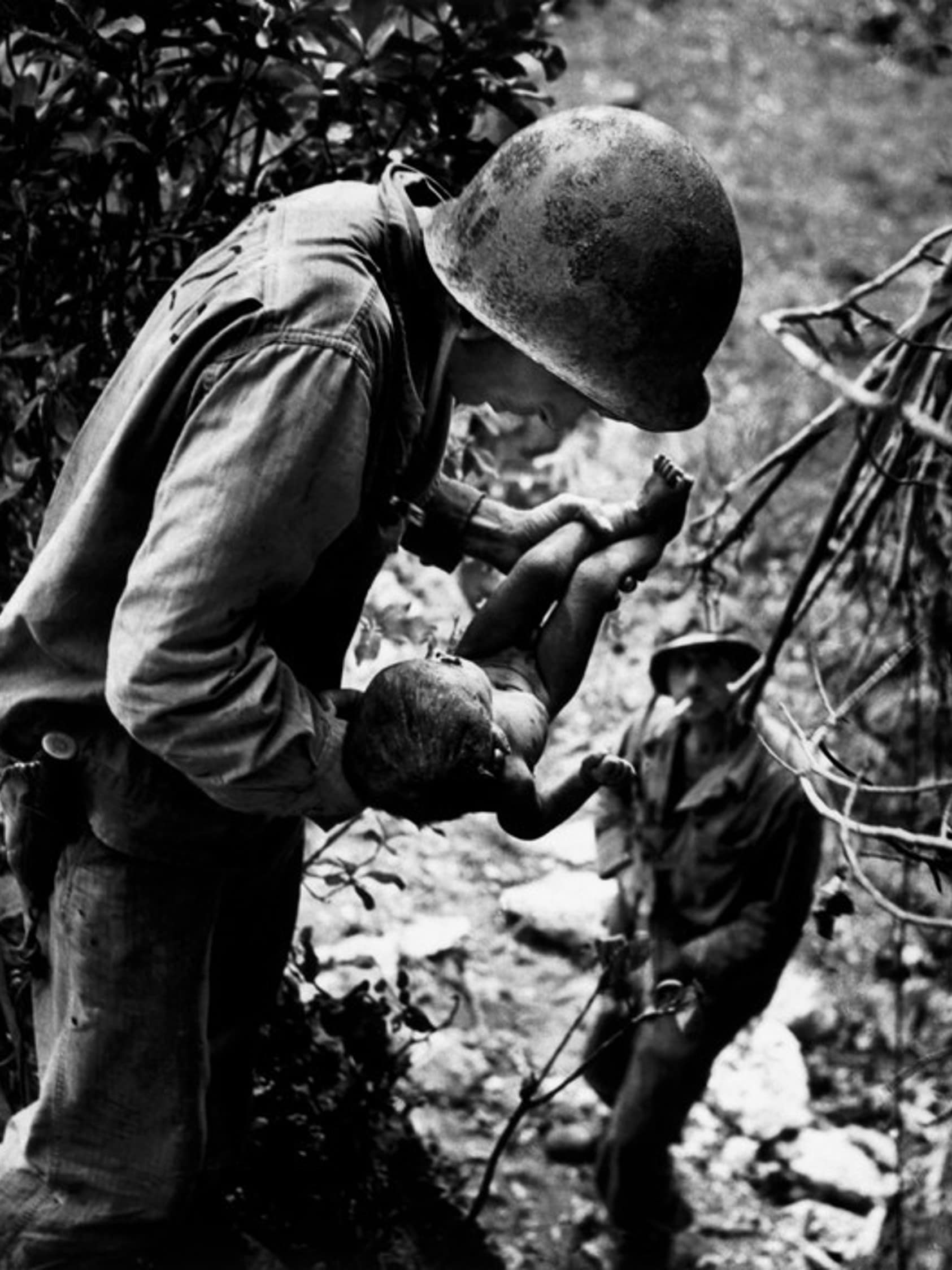 w. eugene smith the battle of saipan island US marine holding and dying baby found in the mountains 1944